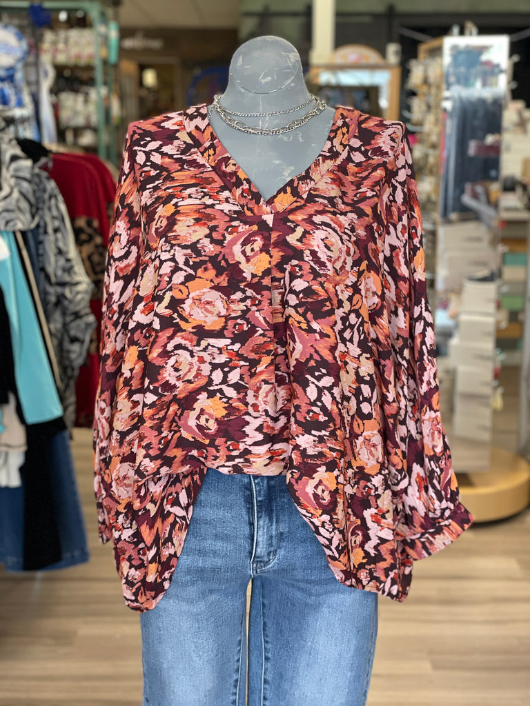 Casual flowy top featuring long sleeves and a V Neckline.